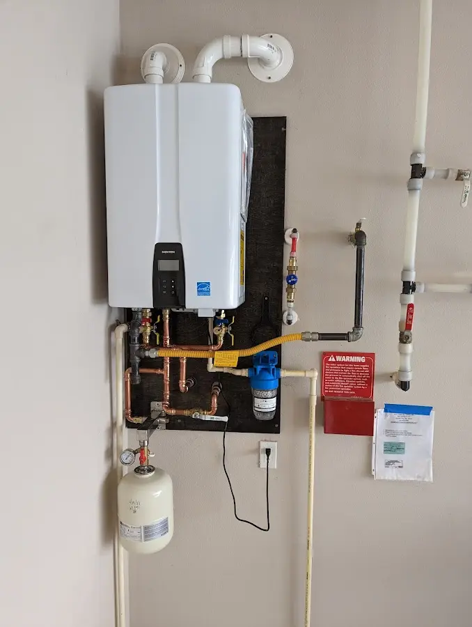 Professional plumber installing copper piping in a Deerfield Beach home